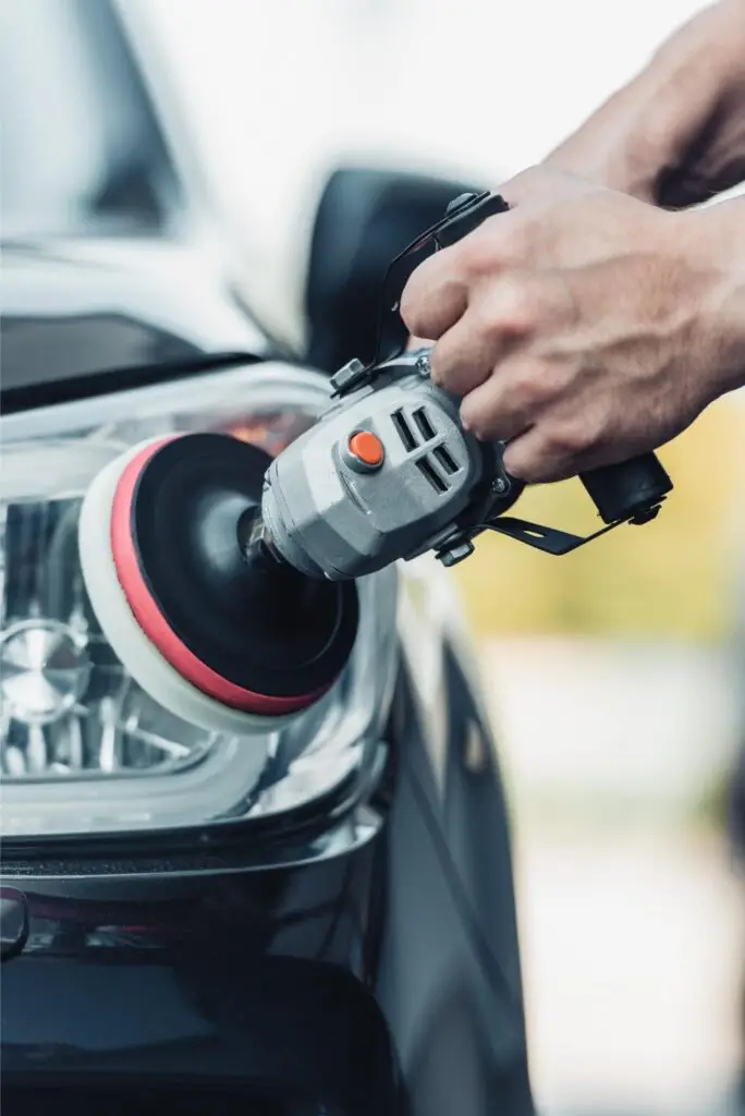 A Medusa detailer polishing a car lamp by hand
