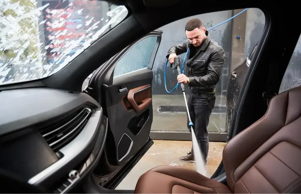 young man washing car on carwash station outdoor 2023 11 27 05 27 22 utc 1 1