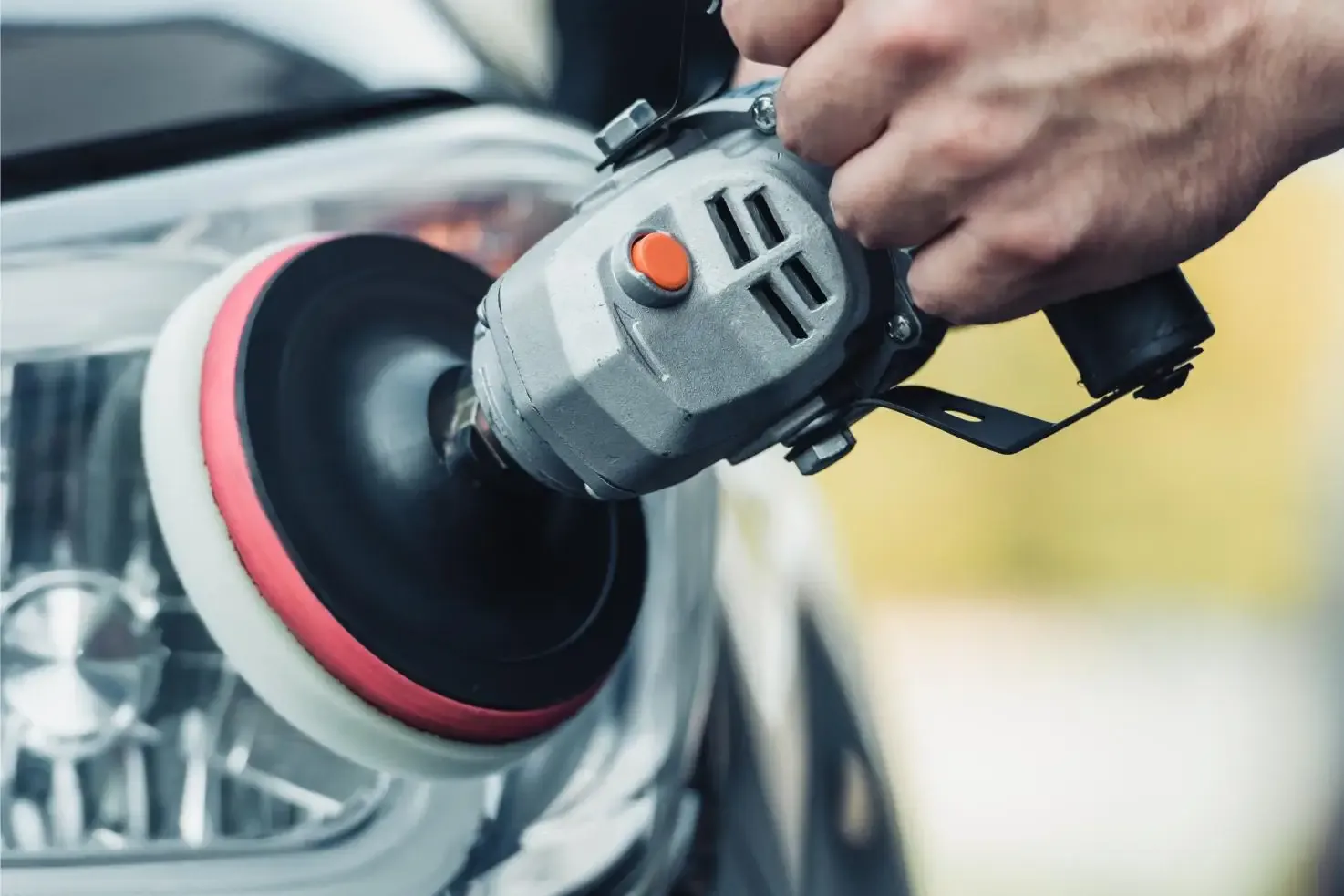 Machine polishing a car headlight in London