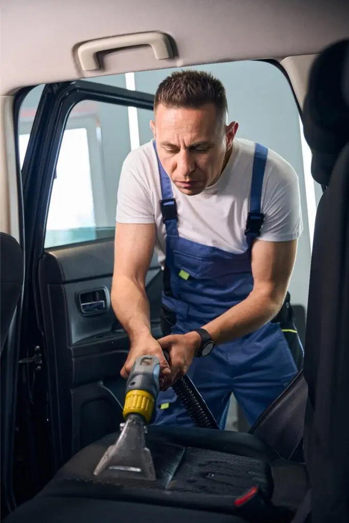 man cleans the car interior with a vacuum cleaner 2024 10 20 00 27 24 utc 1 1