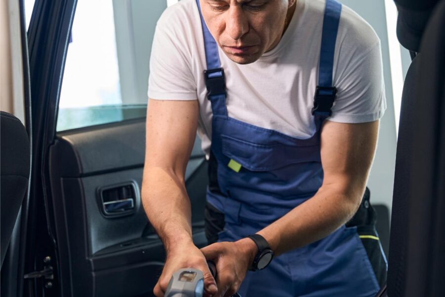 man cleans the car interior with a vacuum cleaner 2024 10 20 00 27 24 utc