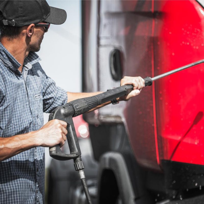 truck-driver-washing-his-vehicle-using-pressure-wa-2023-11-27-05-17-40-utc